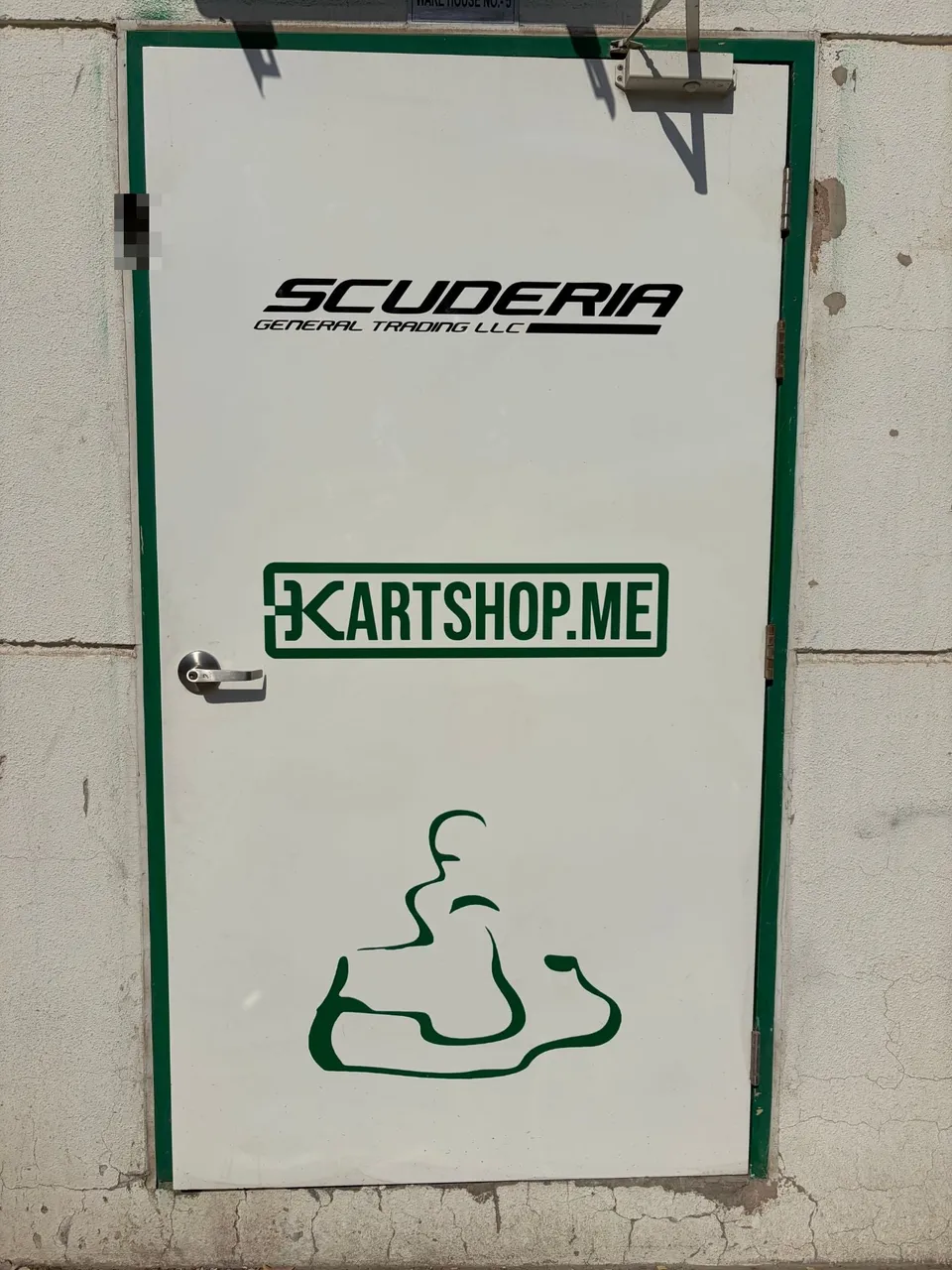 Entrance of Warehouse No. 5, Dubai Investment Park 2, with Scuderia and Kartshop logos