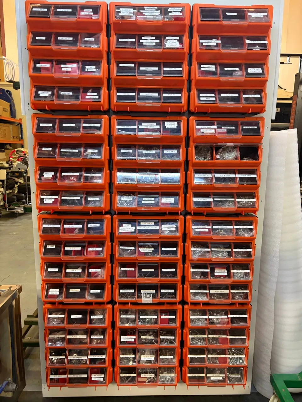 Wall of labelled drawers with nuts, bolts and fittings