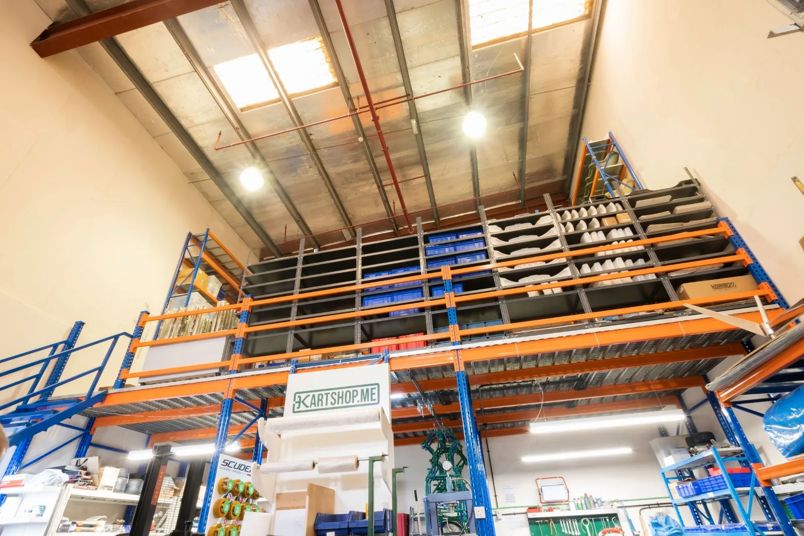 Mezzanine storage with racking full of parts, seen from the warehouse floor