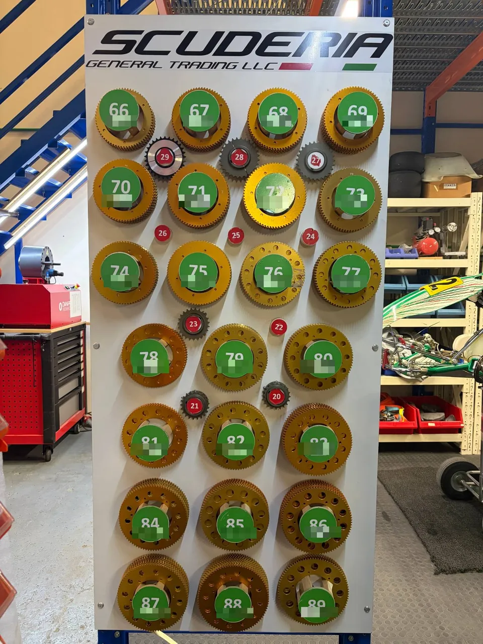 Display of kart sprockets under the Scuderia logo